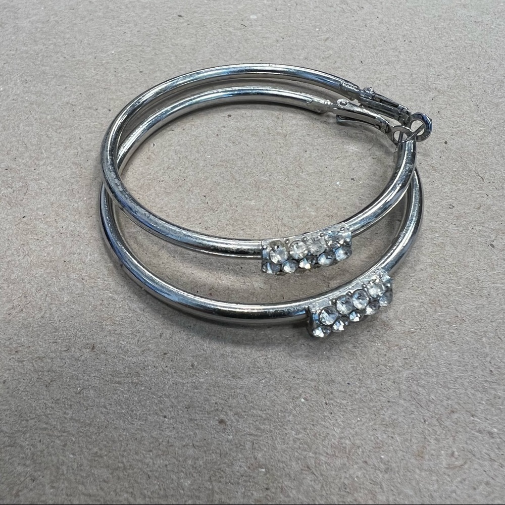 𝅺silver large hoop earrings with rhinestone embellishments on front,